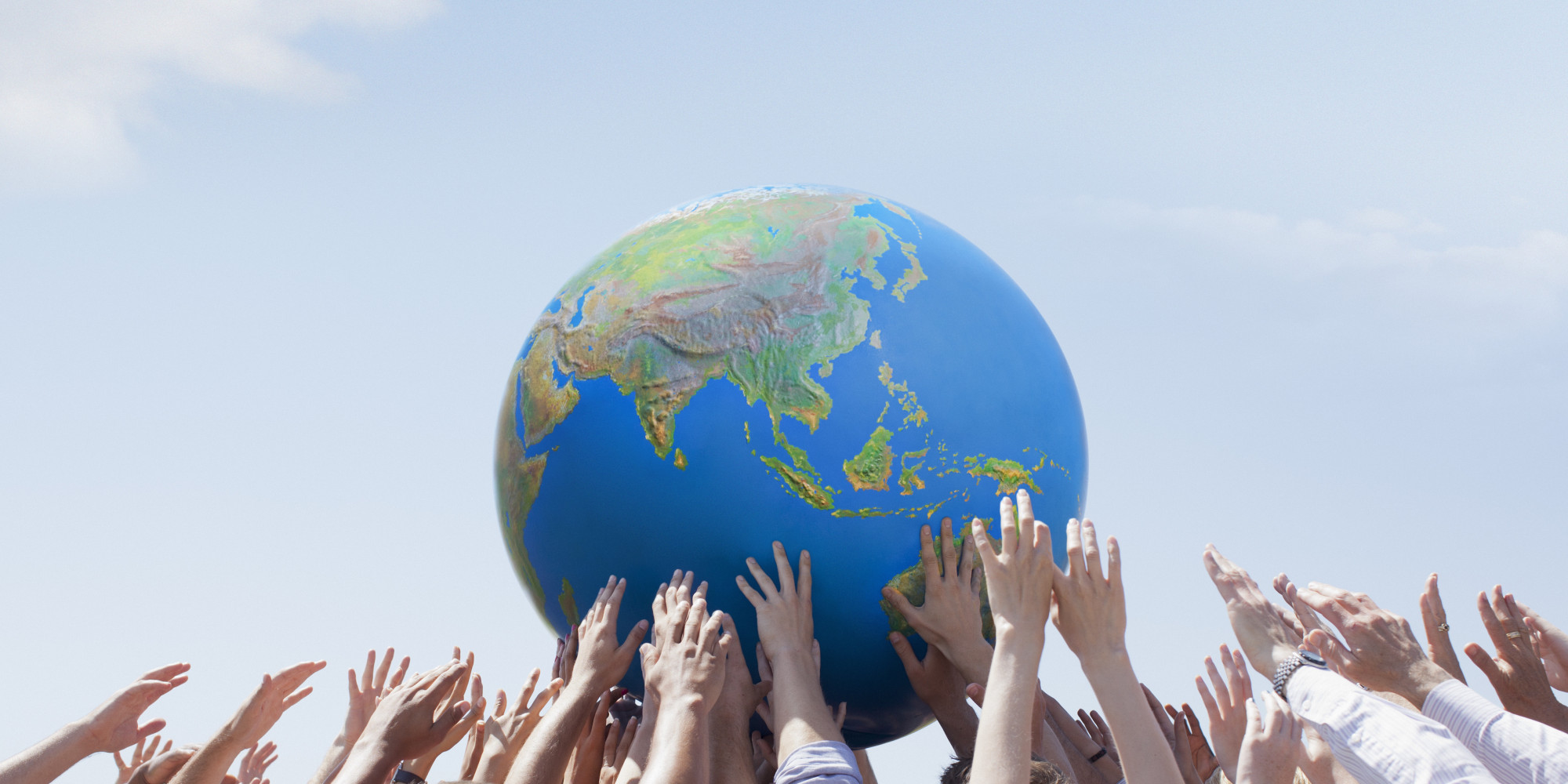 Crowd reaching for globe